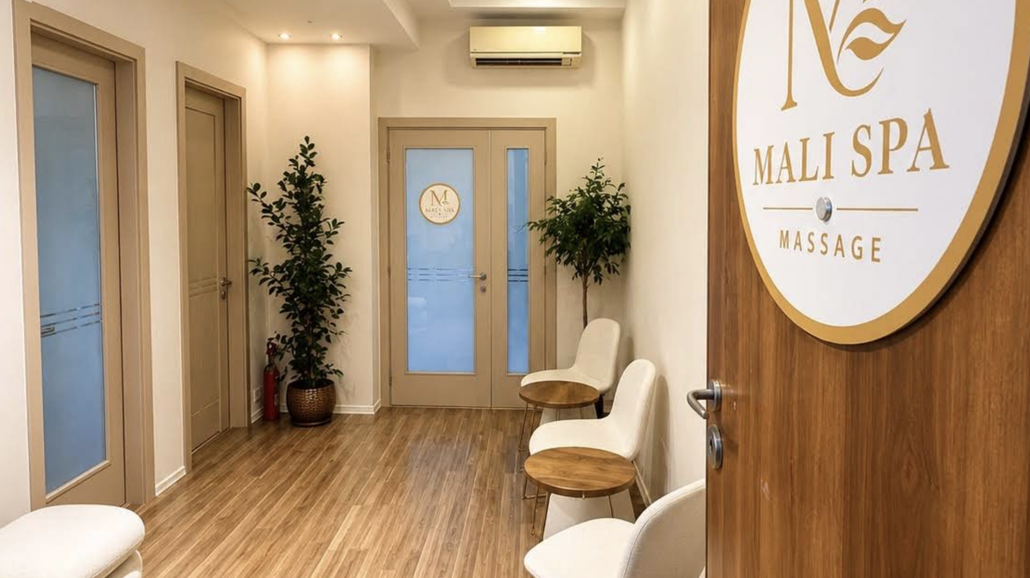Mali Spa's welcoming interior with natural wood and gold signage